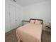 Bedroom with a comfortable bed, soft pink quilt, and neutral decor at 19235 Allium Pl, Orlando, FL 32827