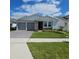 Charming single-story home with a well-manicured lawn, gray garage doors, and a beautiful stone facade at 19235 Allium Pl, Orlando, FL 32827