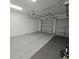 Spacious two-car garage with durable flooring, offering ample parking and storage space at 19235 Allium Pl, Orlando, FL 32827