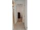 Bright hallway with wood-look tile flooring and a view into a room at 19235 Allium Pl, Orlando, FL 32827