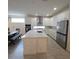 Open kitchen with a large island, stainless steel appliances, and ample cabinet space at 19235 Allium Pl, Orlando, FL 32827