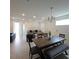 Open-concept living room and dining area with lots of natural light and modern chandelier at 19235 Allium Pl, Orlando, FL 32827