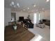 Bright open-concept space with tile floors, ample seating, and large windows for natural light at 19235 Allium Pl, Orlando, FL 32827