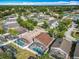 Wide aerial view featuring homes with screened pools in a community near a lake at 207 Bailey Cir, Davenport, FL 33897