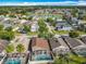An aerial view shows a neighborhood with screened in pools and a pond with a fountain at 207 Bailey Cir, Davenport, FL 33897