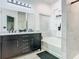 Elegant bathroom features double vanity, soaking tub, and luxurious marble-style tiling at 207 Bailey Cir, Davenport, FL 33897