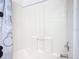 All-white bathtub and shower combination with Mickey Mouse curtain rod at 207 Bailey Cir, Davenport, FL 33897