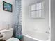 Bright bathroom features a shower and bathtub combination with window at 207 Bailey Cir, Davenport, FL 33897