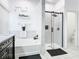 Updated bathroom featuring tub, glass shower with niche, and sleek modern design at 207 Bailey Cir, Davenport, FL 33897