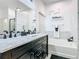 Bathroom boasts double sinks with marble countertops, soaking tub, and stylish fixtures at 207 Bailey Cir, Davenport, FL 33897
