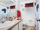 Bright bathroom with Mickey Mouse themed shower curtain and decor at 207 Bailey Cir, Davenport, FL 33897