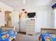 Cozy bedroom with carpet flooring, tv, and closet at 207 Bailey Cir, Davenport, FL 33897