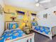 Bright bedroom featuring a Winnie the Pooh theme, two twin beds, and a ceiling fan at 207 Bailey Cir, Davenport, FL 33897