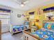 Bright bedroom with Winnie the Pooh theme, two twin beds, and plenty of natural light at 207 Bailey Cir, Davenport, FL 33897