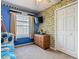 Bright bedroom with minion wallpaper, window, and closet at 207 Bailey Cir, Davenport, FL 33897