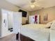 Primary bedroom with adjacent bathroom, flat screen television, and natural light at 207 Bailey Cir, Davenport, FL 33897