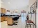 Spacious kitchen featuring an island, black countertops, stainless steel appliances, and breakfast bar seating at 207 Bailey Cir, Davenport, FL 33897