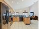 Open kitchen with black appliances, granite countertops, light wood cabinets, and a view into the living area at 207 Bailey Cir, Davenport, FL 33897