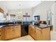 Bright kitchen features a black countertop, black appliances, and natural wood cabinets at 207 Bailey Cir, Davenport, FL 33897