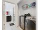 Convenient laundry room with modern machines and extra bathroom at 207 Bailey Cir, Davenport, FL 33897