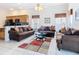 Bright living room features tile flooring, comfortable couches, and an open kitchen at 207 Bailey Cir, Davenport, FL 33897