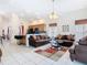 Open living room with tile flooring and comfortable seating, with views of the kitchen at 207 Bailey Cir, Davenport, FL 33897