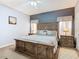 Calm bedroom features a large wooden bed frame, bedside tables, and plush carpeting at 207 Bailey Cir, Davenport, FL 33897