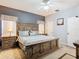 Large primary bedroom featuring a decorative wood headboard, side tables with lamps, and carpeted flooring at 207 Bailey Cir, Davenport, FL 33897