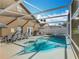 Inviting screened pool and patio area with comfortable lounge chairs and ample space for enjoyment at 207 Bailey Cir, Davenport, FL 33897