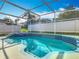 Sparkling screened pool and backyard with lush green surroundings, perfect for summer relaxation at 207 Bailey Cir, Davenport, FL 33897