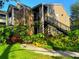 Inviting two-story home with lush landscaping, brick accents, and an exterior staircase at 2213 Metropolitan Way # 1318, Orlando, FL 32839