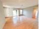 Spacious living room with natural light, laminate floors, and sliding door to outdoor patio at 2213 Metropolitan Way # 1318, Orlando, FL 32839