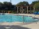 Relaxing pool area with sun loungers and shaded seating, a perfect amenity at 2213 Metropolitan Way # 1318, Orlando, FL 32839