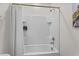 This bathroom offers a bright white tiled shower-tub combination with a shower curtain at 2302 Tay Wes Dr, St Cloud, FL 34771
