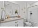 This bright bathroom offers a shower-tub combo with stylish gold fixtures and Eiffel tower decor at 2302 Tay Wes Dr, St Cloud, FL 34771