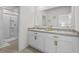 This bathroom includes double sinks, white cabinetry, and a bright, well-lit mirror at 2302 Tay Wes Dr, St Cloud, FL 34771