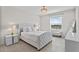 This bedroom offers a view, a crystal chandelier, and a stylish upholstered headboard at 2302 Tay Wes Dr, St Cloud, FL 34771