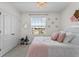 A bright bedroom with view, adorned with a crystal chandelier and charming decor at 2302 Tay Wes Dr, St Cloud, FL 34771