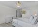 This airy bedroom features a modern chandelier and a view from the window at 2302 Tay Wes Dr, St Cloud, FL 34771