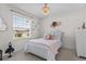 This cheerful bedroom has a window view, a white headboard, and a sparkling chandelier at 2302 Tay Wes Dr, St Cloud, FL 34771