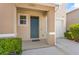 Inviting entryway featuring a blue front door, covered porch, and convenient access to the garage at 2302 Tay Wes Dr, St Cloud, FL 34771