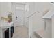 Bright entryway with decorative table, stools, and staircase leading to the upper level at 2302 Tay Wes Dr, St Cloud, FL 34771