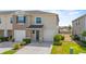 Well-manicured lawn and garden beds enhance the curb appeal of this charming townhome at 2302 Tay Wes Dr, St Cloud, FL 34771