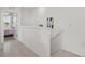 Hallway with railing and view to bedroom with natural light at 2302 Tay Wes Dr, St Cloud, FL 34771