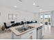 Open kitchen with island sink, stainless dishwasher, and view of dining and living areas at 2302 Tay Wes Dr, St Cloud, FL 34771