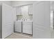 This laundry room contains modern appliances, storage, and is conveniently tucked behind double doors at 2302 Tay Wes Dr, St Cloud, FL 34771