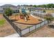 A secure community playground with slides, swings and a wood-chip play area at 2302 Tay Wes Dr, St Cloud, FL 34771