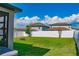A spacious, green backyard enclosed with a white fence provides privacy and ample room for activities at 2310 Raven Ridge Rd, Minneola, FL 34715