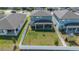 Spacious backyard with a well-maintained lawn, white fence, and covered patio area, perfect for outdoor living at 2310 Raven Ridge Rd, Minneola, FL 34715