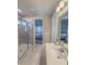 Bright bathroom featuring a glass shower and a vanity with a white countertop at 2310 Raven Ridge Rd, Minneola, FL 34715